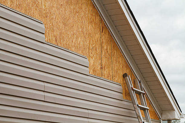 Professional Storm Damage Siding Repair technician working in White Hall, WV